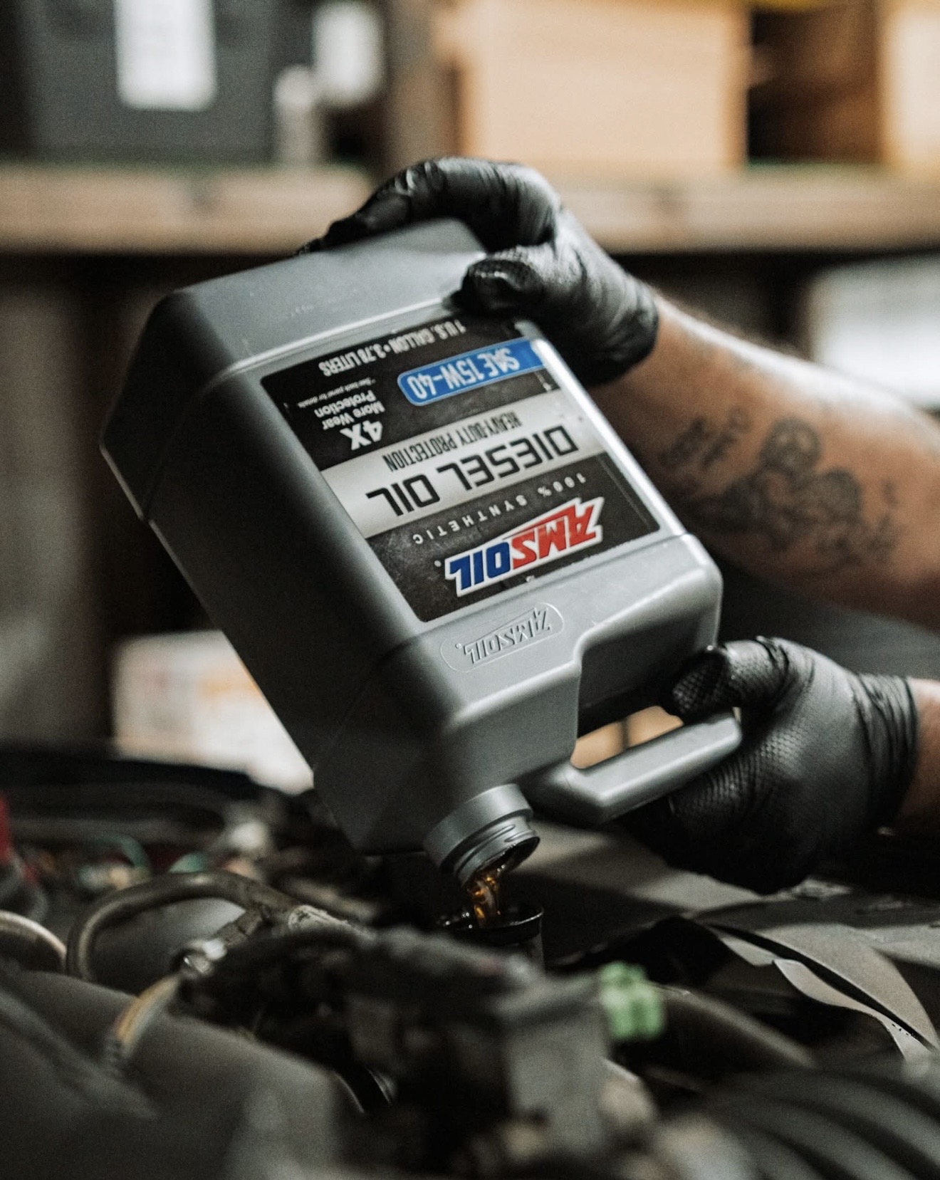 AMSOIL synthetic diesel oil being installed during an oil change at Adams Grandview Auto Repair in Grandview, WA