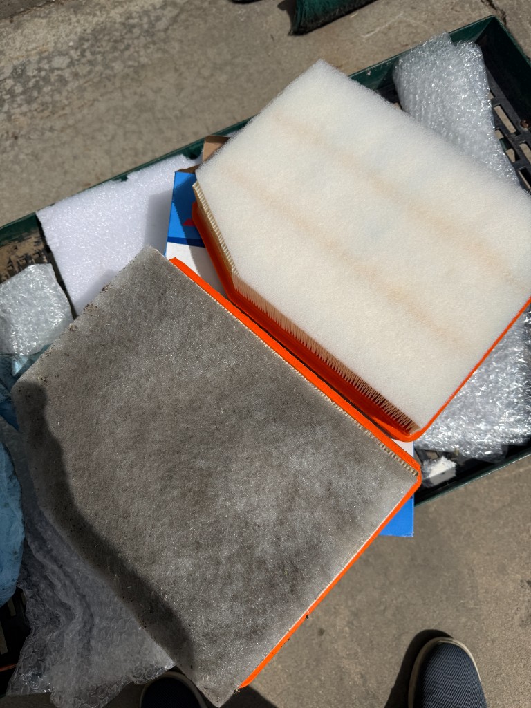 Dirty engine air filter replaced with new OEM filter