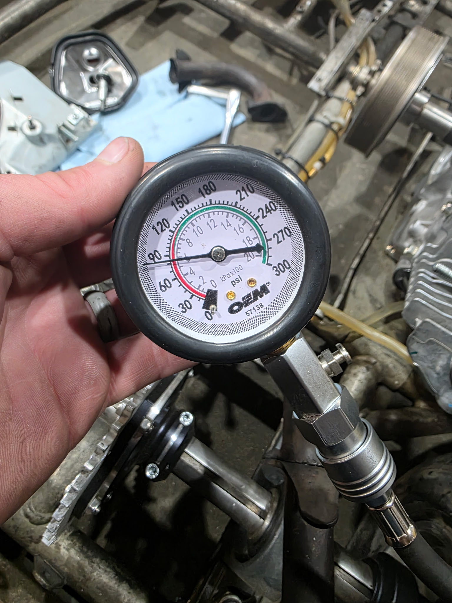 Engine compression test with diagnostic gauge