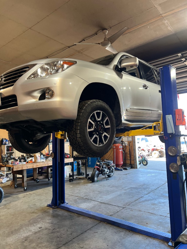 Lexus SUV on lift for suspension and wheel service